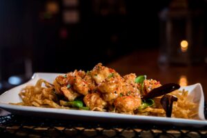 Plate of Sunset Shrimp tossed in garlic chili sauce