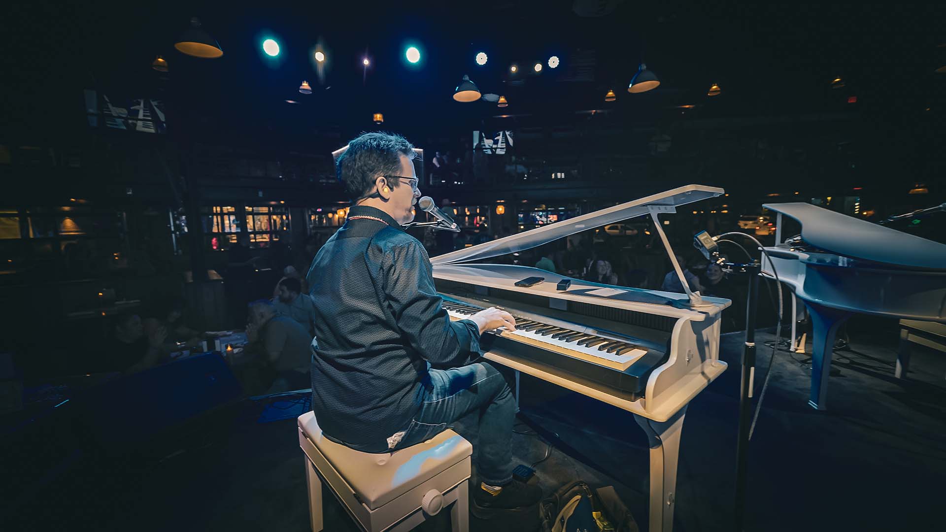 Dockside Dueling Pianos performer playing on stage at The Wharf