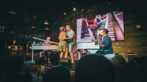Couple dancing on stage during a Dockside Dueling Pianos performance